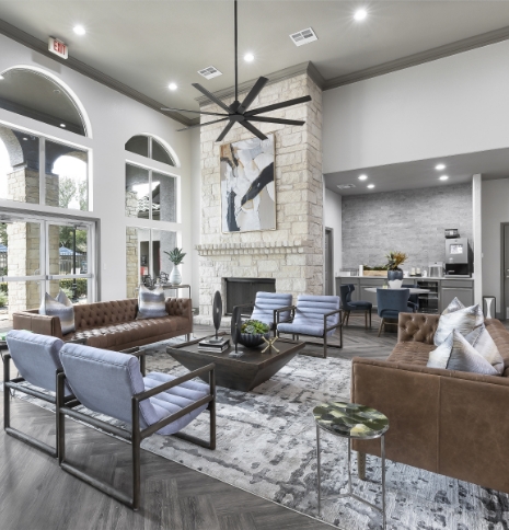 inside of the clubhouse with a large open space seating area and high ceiling