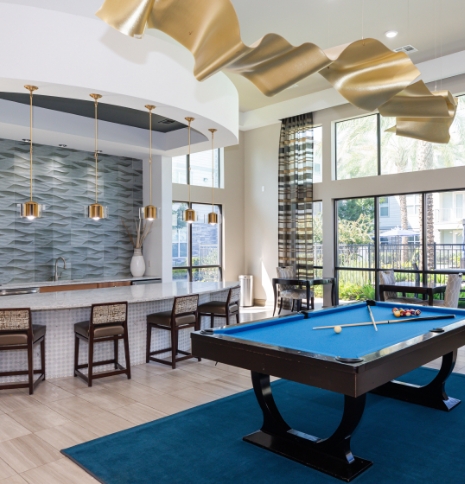 inside of the clubhouse with a large counter and pool table