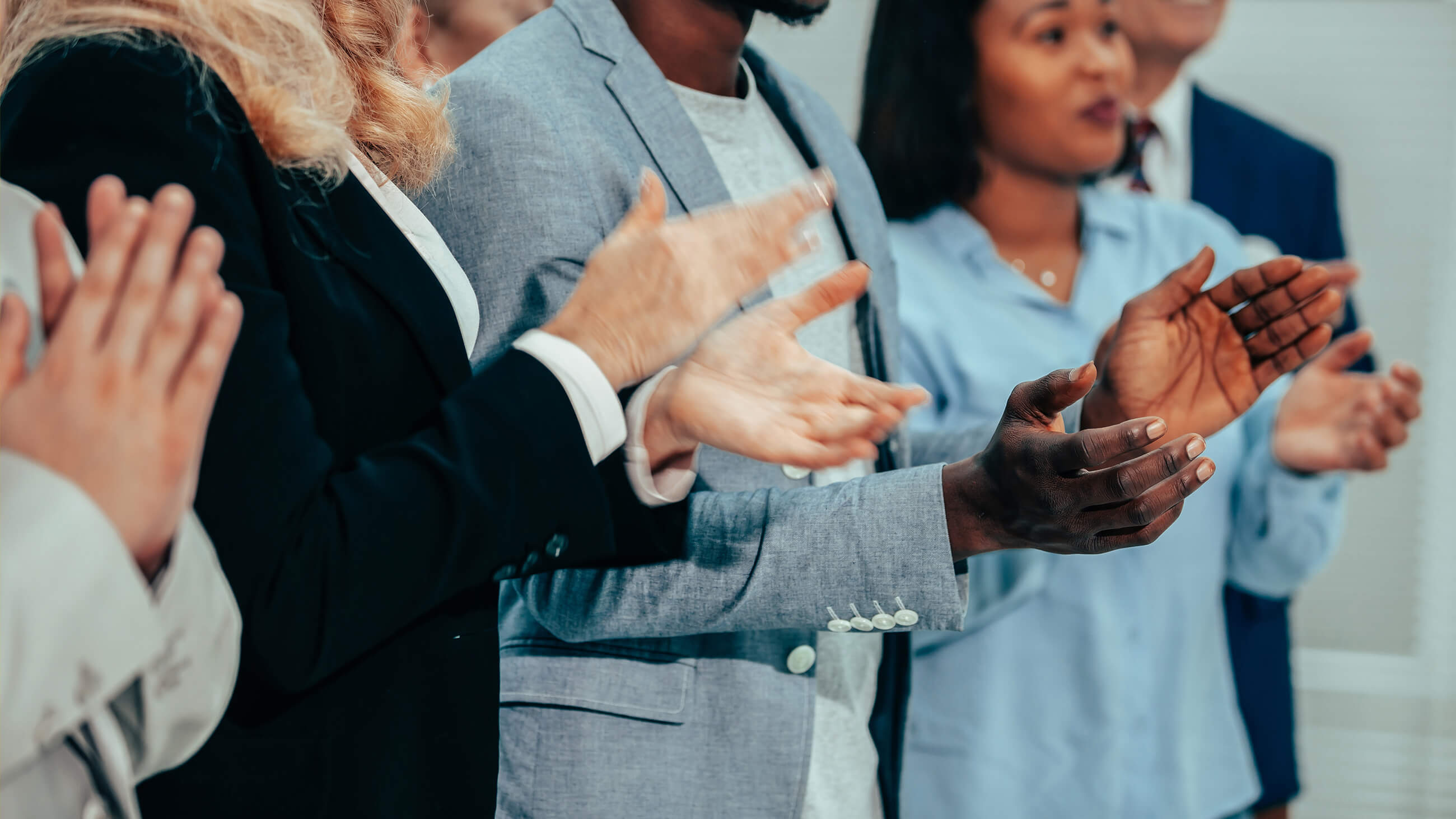 five people in business attires applauding