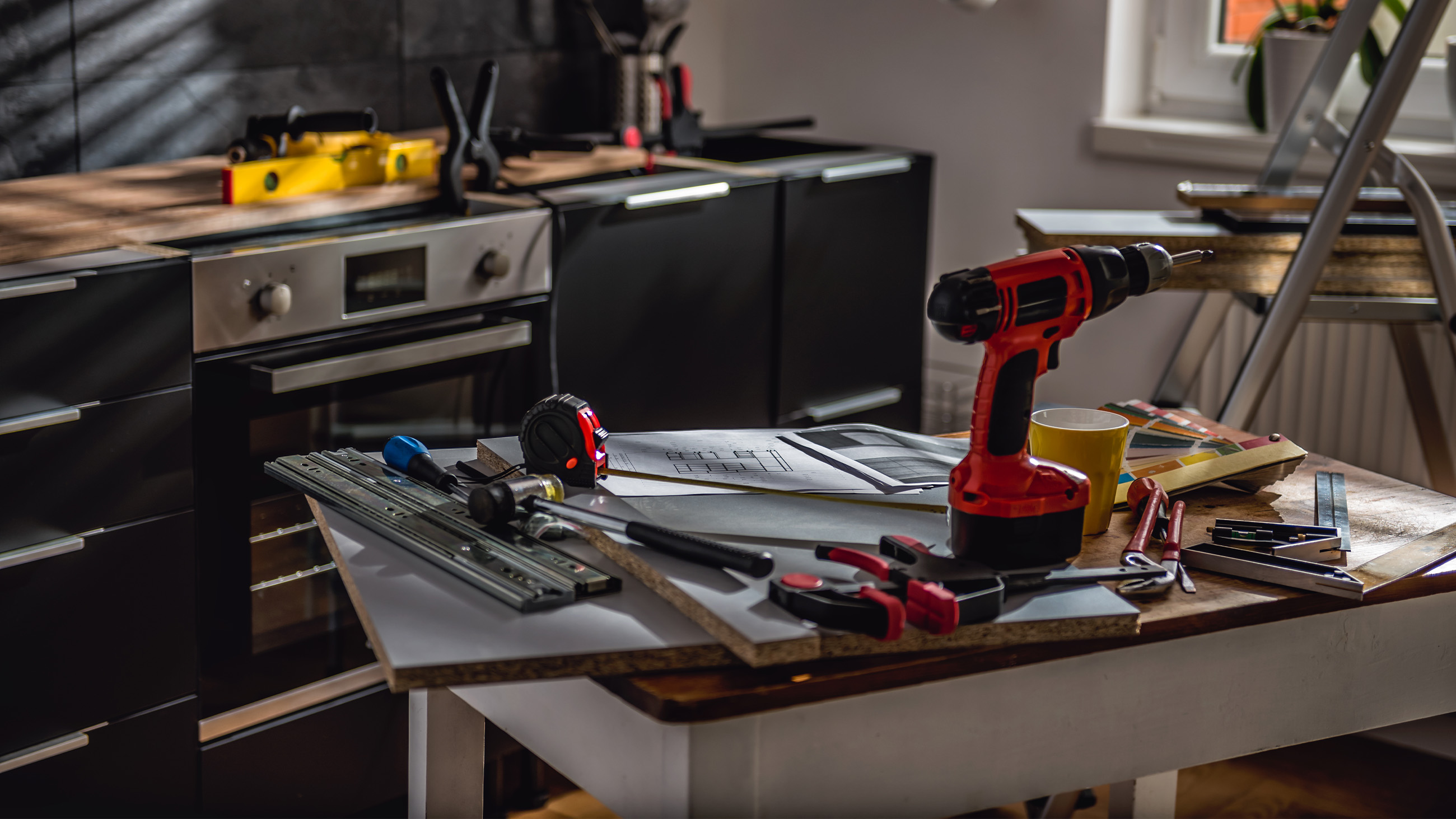 work tools on an island counter in a kitchen under construction